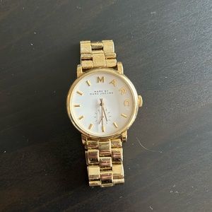 Marc Jacob’s gold watch with white face